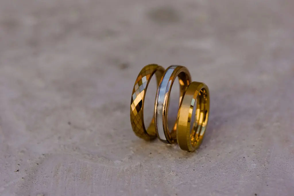 Three Rose Gold Engagement Rings on Marble Backdrop