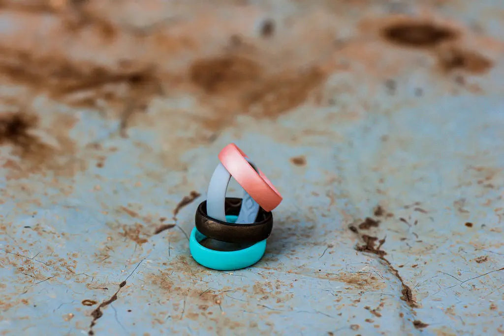 Light Blue, Brown, Grey and Orange Silicone Rings Stacked on top of One Another