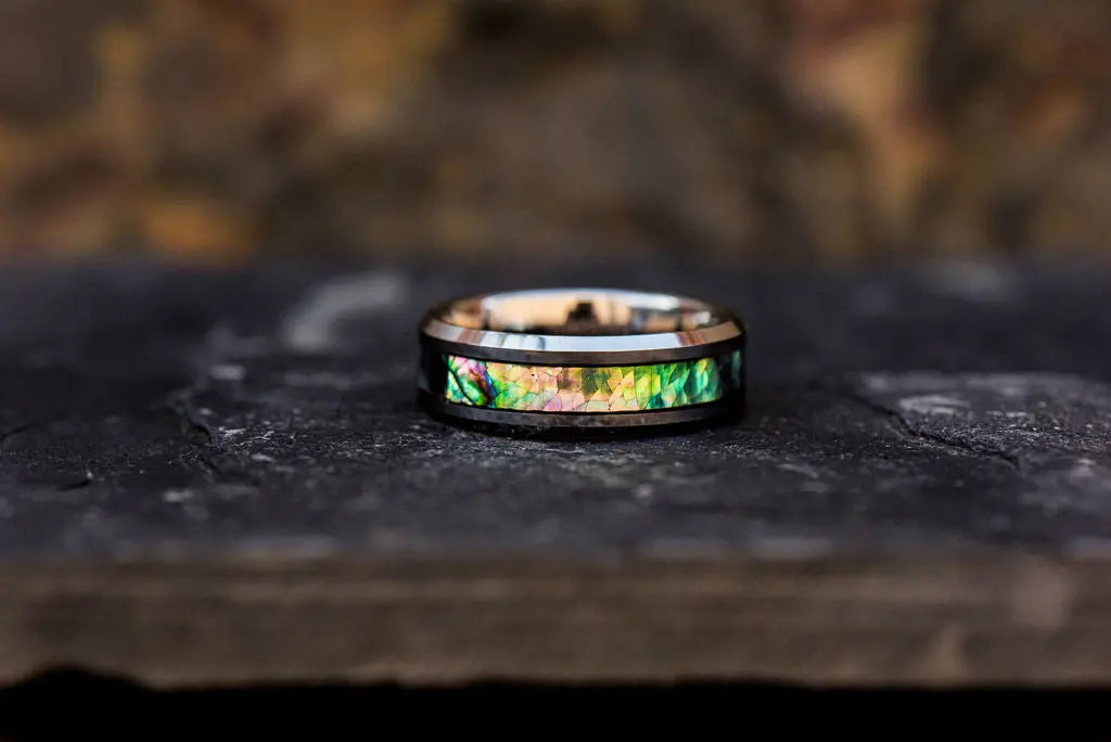 Bespoke Silver Ring With Rainbow color inlays on rustic backdrop