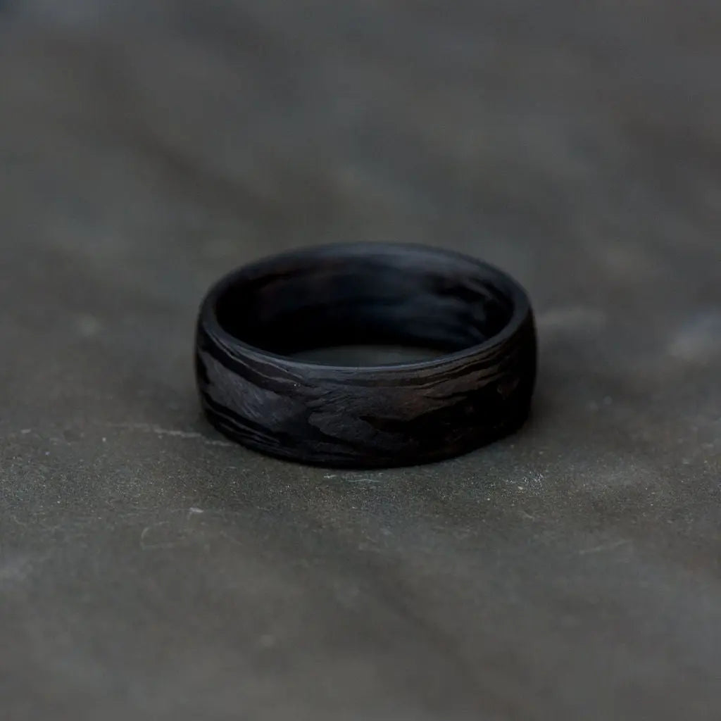 Black Carbon Fibre Ring on Grey Backdrop