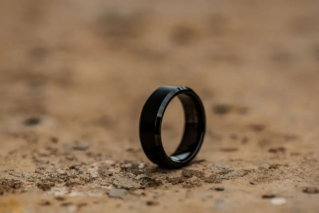 Black Titanium Ring on Sandy Backdrop