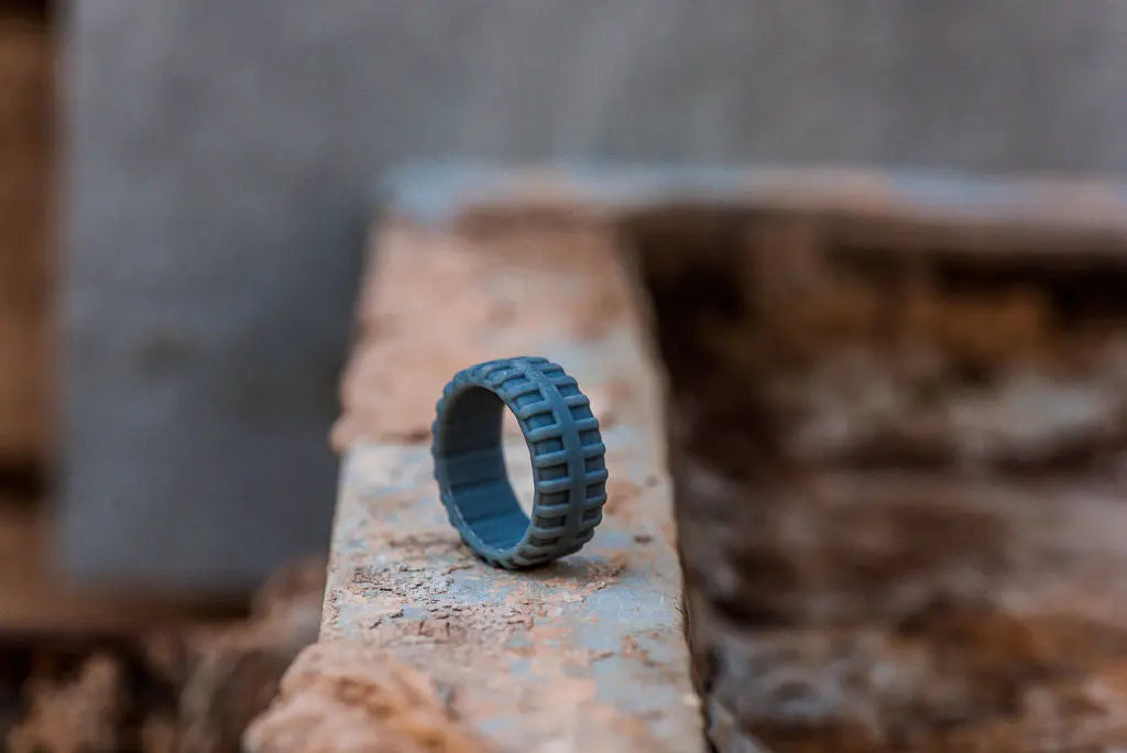 Grey Silicone Ring Standing on It's Side on Rustic Backdrop