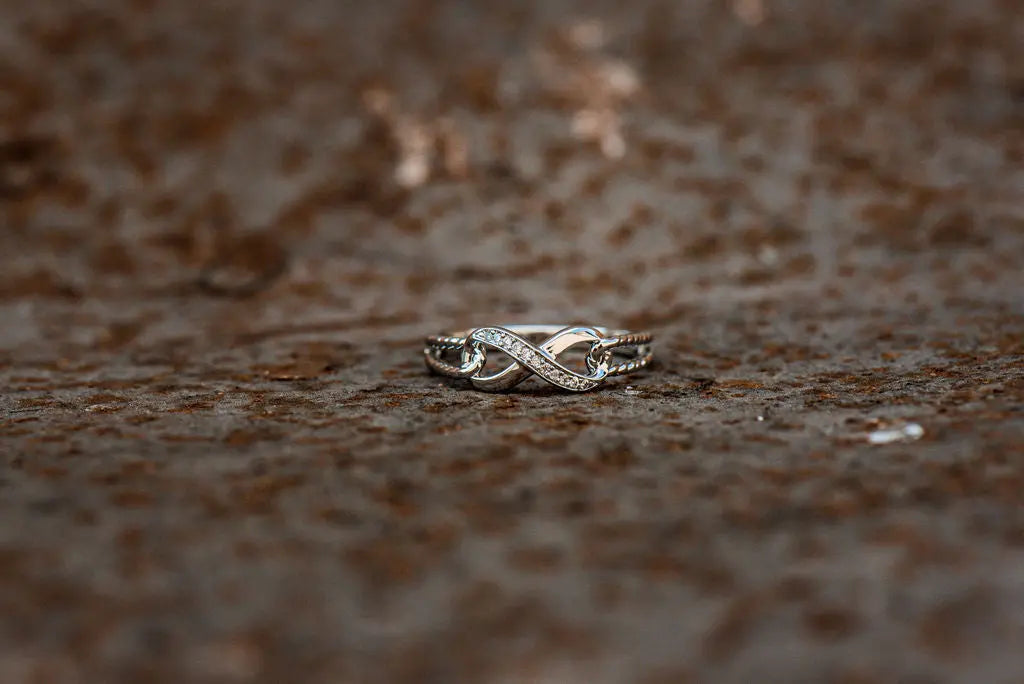 Sterling Silver Moissanite Wedding Ring on Rustic Backdrop
