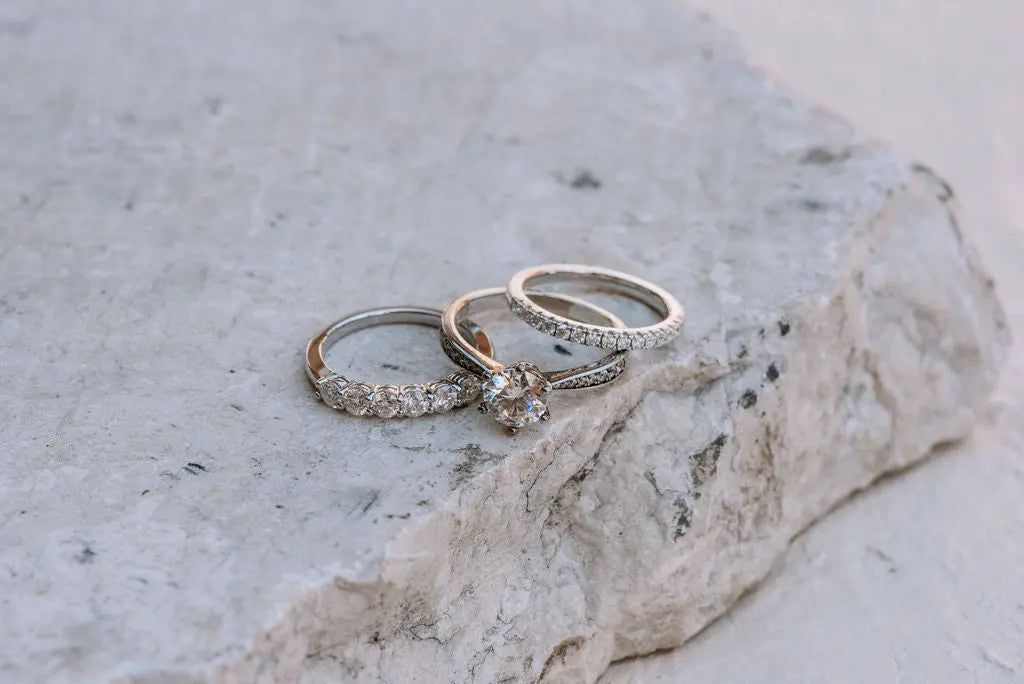 Three Sterling Silver Moissanite Rings Laying on One Another
