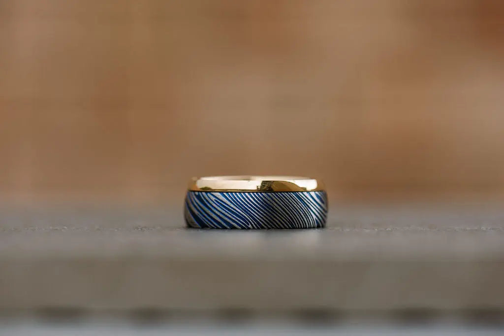 Blue damascus steel ring with gold outer half
