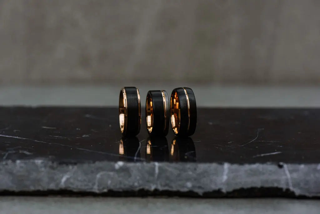 three black and gold tungsten carbide rings