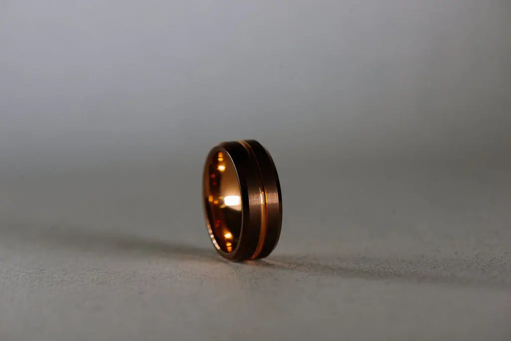 Gold Tungsten Carbide Ring on Grey Backdrop