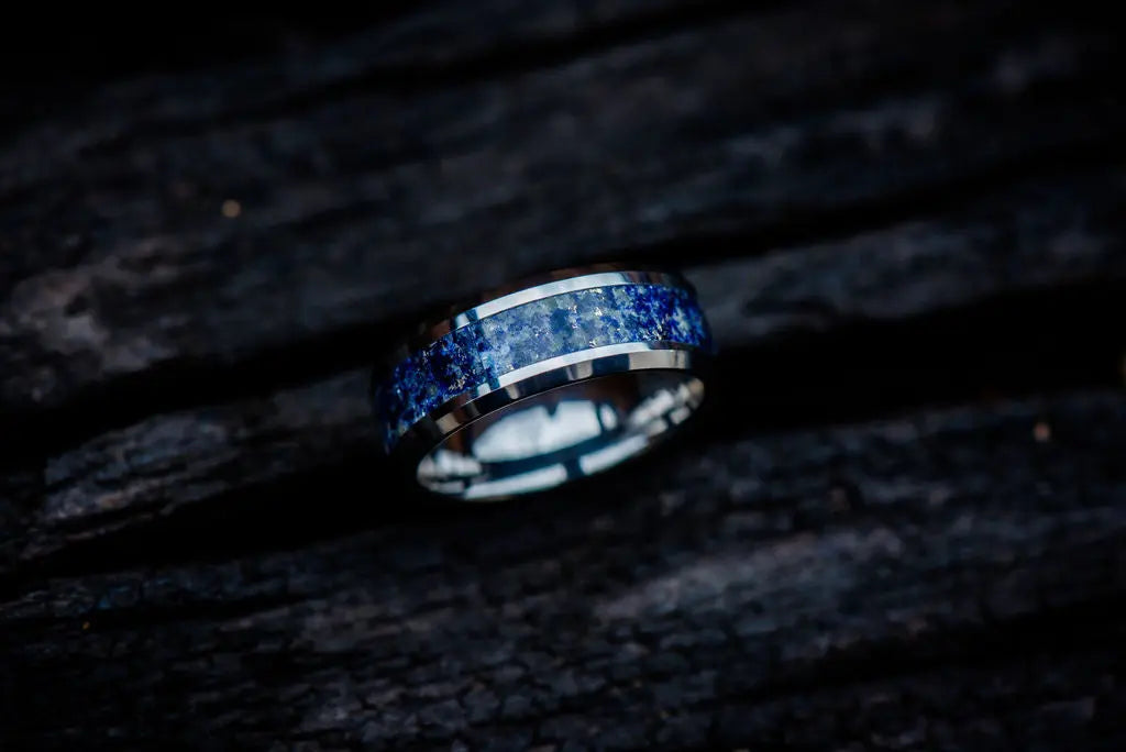 Silver Bespoke Ring with Shiny Crushed Blue Gemstone Inlay on Dark Backdrop