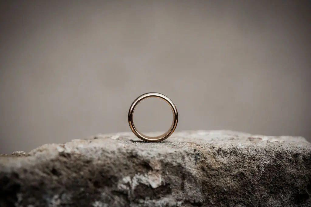 Side Profile View of Wedding Ring Sitting on a Rock