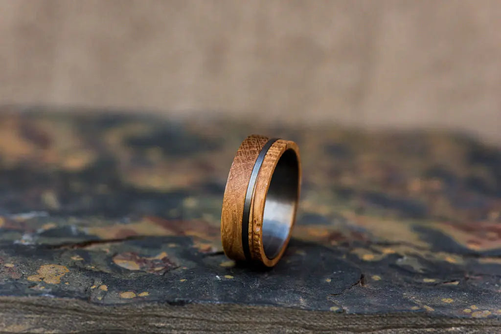 Wooden Inlay Ring on It's Side on Rustic Backdrop