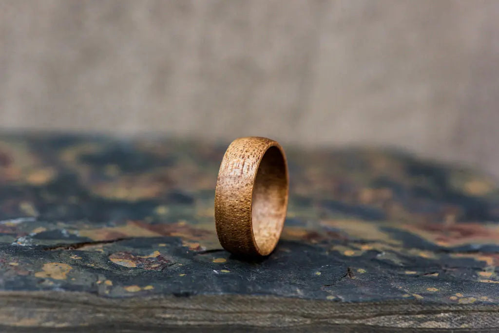 Koa Wood Ring on Rustic Backdrop