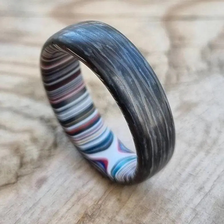 Fordite rings with carbon fibre and glow powder
